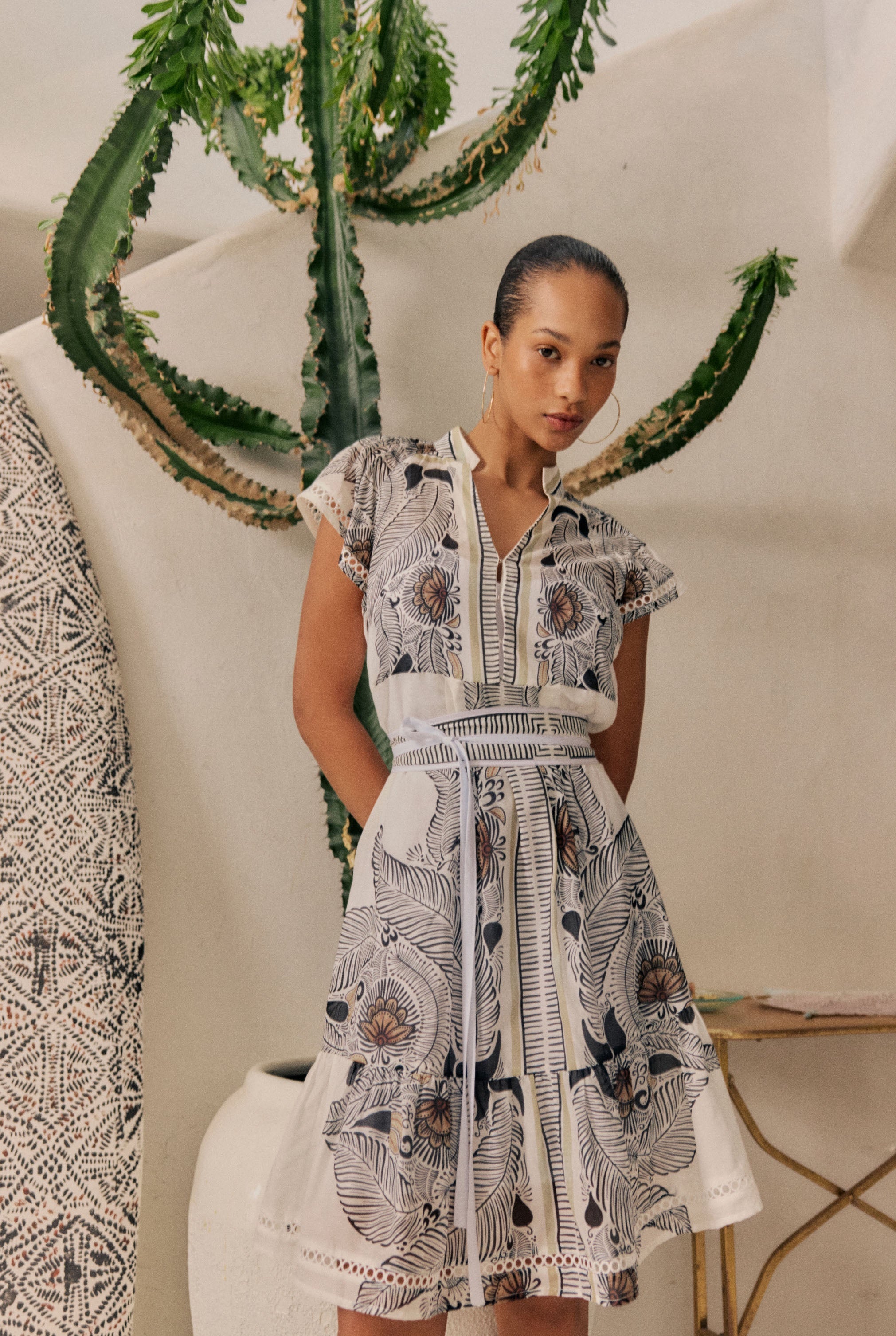 Lanaberg model in vintage-inspired printed dress next to antique book stack — Melbourne fashion boutique