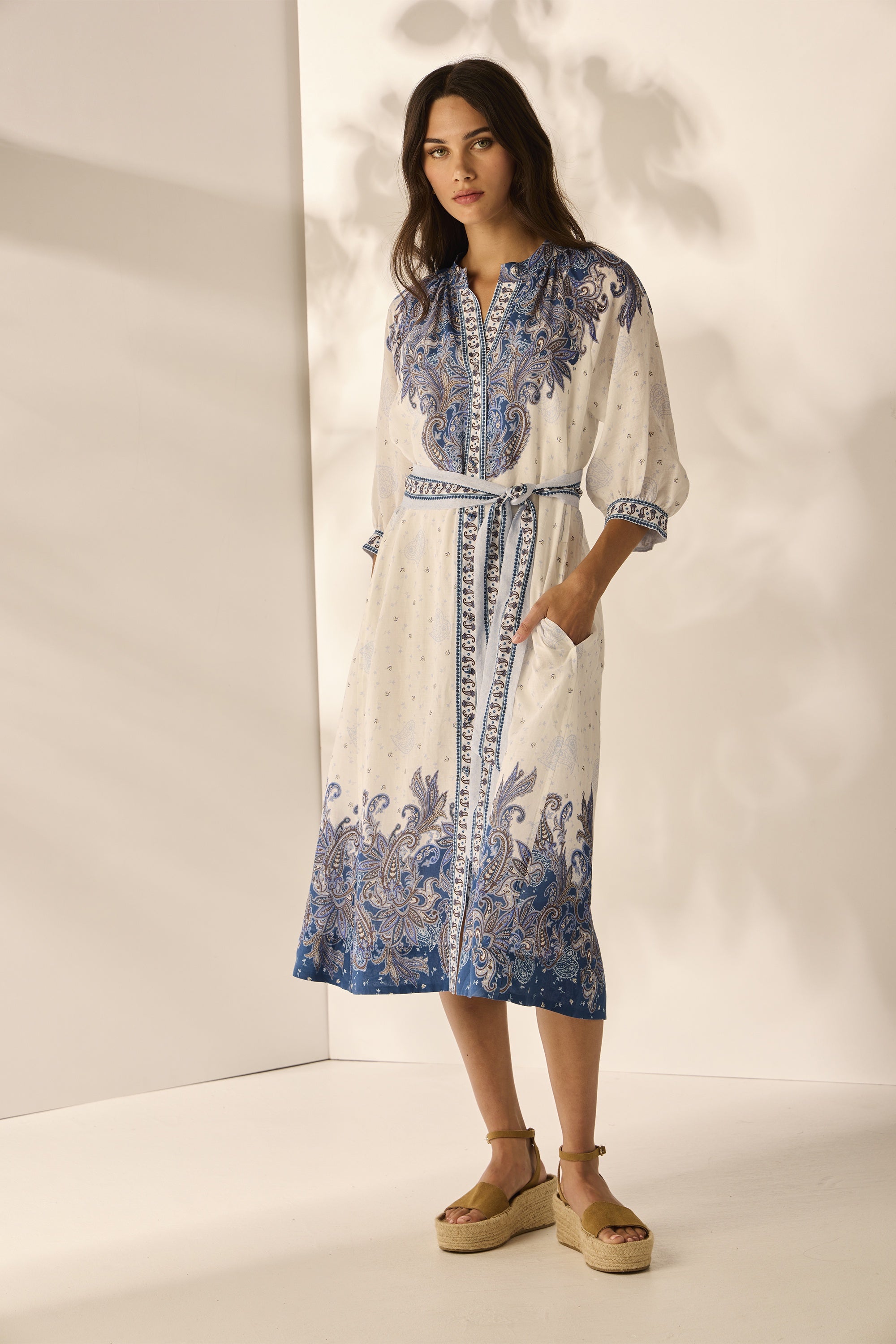 Lanaberg model in floral boho dress with boots walking along black sand beach — Melbourne Australia fashion store